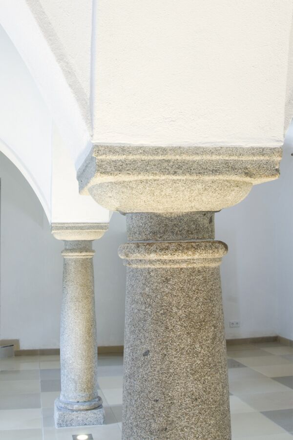 Heller Wohnraum mit antiken Granitsäulen als Widerlager für verputztes Gewölbe